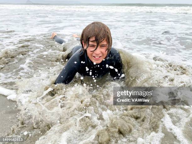 tween playing in the surf and waves during summer break - miss world stock pictures, royalty-free photos & images