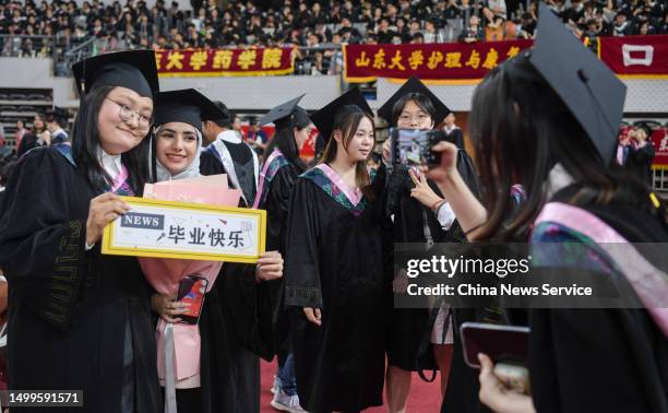 Graduates pose for a photo during 2023 Shandong University Commencement Ceremony on June 18, 2023 in Jinan, Shandong Province of China.