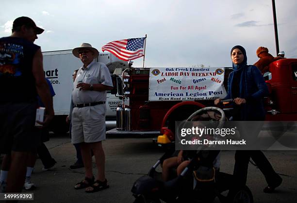 Mourners and supporters of the Sikh Temple of Wisconsin attend a candle light vigil held at the Oak Creek Community Center on the National Night Out...