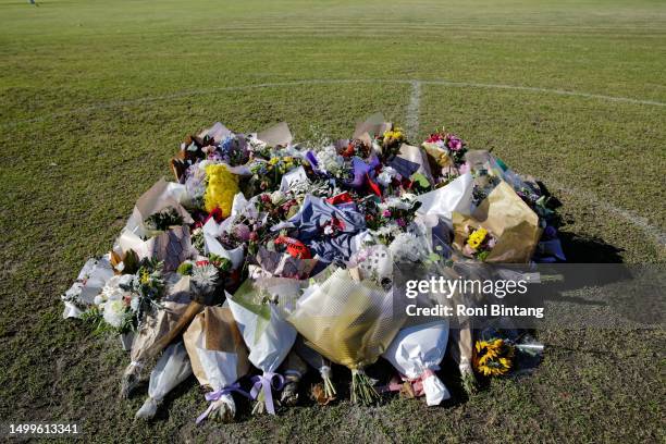 Floral tributes are shown at the oval for the victims of the deadly Hunter Valley bus crash on June 19, 2023 in Singleton, Australia. Ten people were...