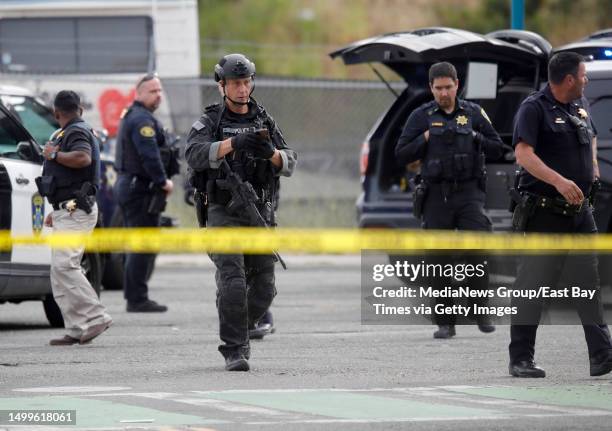 Oakland and San Leandro police respond after a robbery suspect would not leave his vehicle on San Leandro Street near the Coliseum BART station in...