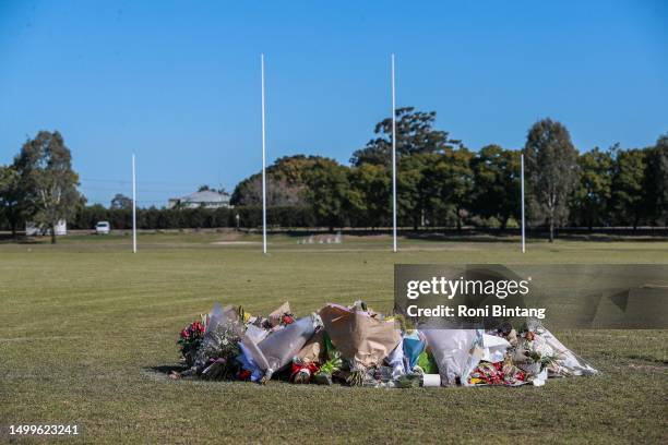 Floral tributes are shown at the oval for the victims of the deadly Hunter Valley bus crash on June 19, 2023 in Singleton, Australia. Ten people were...