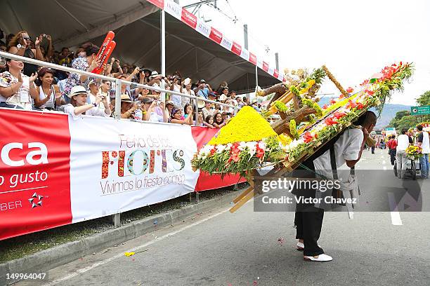 Farmer walks carrying a silleta in the traditional 55th Desfile de Silleteros during the Feria De Flores 2012 at Guayaquil Bridge on August 7, 2012...