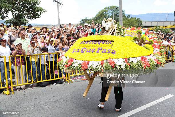 Farmer walks carrying a silleta in the traditional 55th Desfile de Silleteros during the Feria De Flores 2012 at Guayaquil Bridge on August 7, 2012...