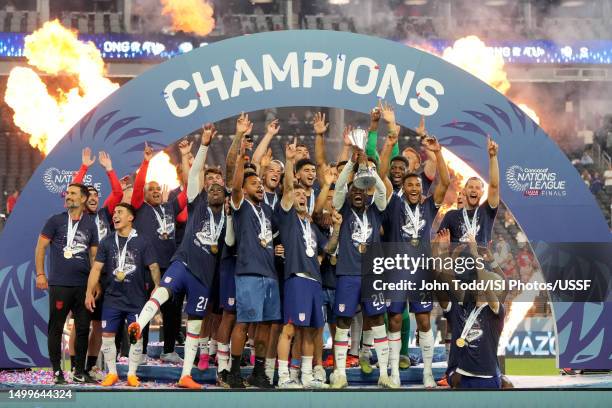 Folarin Balogun of the United States holds the championship trophy celebrating the United States Mens National Team's victory over Canada after the...