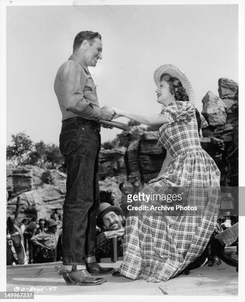 Gene Autry and Gail Davis have mutual admiration for each other in a scene from the film 'The Old West', 1952.