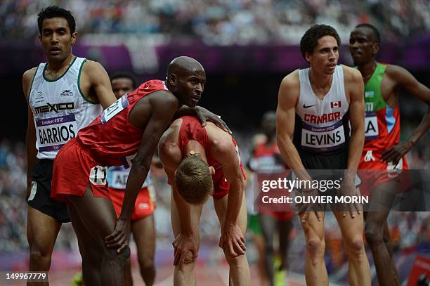 Mexico's Juan Luis Barrios, US' Bernard Lagat and Canada's Cameron Levins are seen after competing in the men's 5000m heats at the athletics event of...