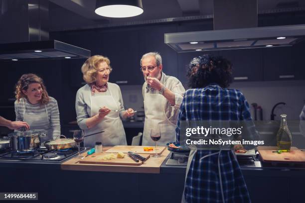 a group of people enjoying a cooking class - cooking contest stock pictures, royalty-free photos & images