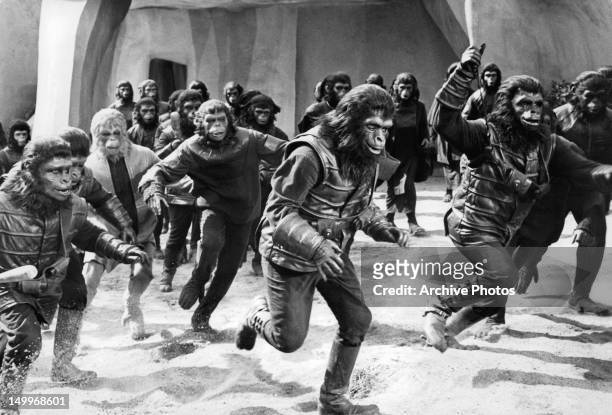 Gorillas and chimps give chase through the city in a scene from the film 'Planet Of The Apes', 1968.