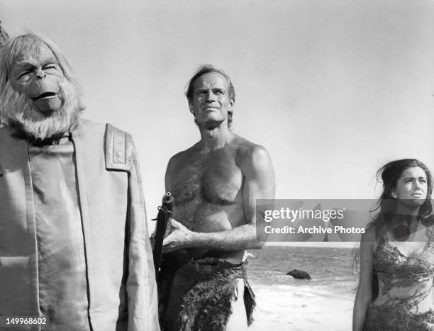 Maurice Evans, Charlton Heston, and Linda Harrison looking up from the beach in a scene from the film 'Planet Of The Apes', 1968.