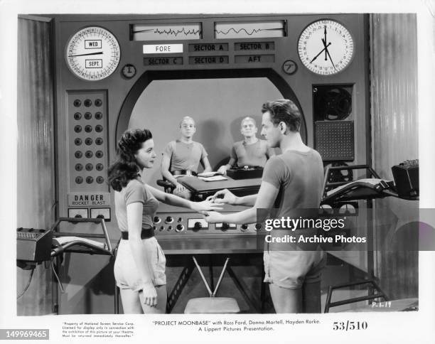 Donna Martell gets ring from Ross Ford in a scene from the film 'Project Moon Base', 1953.