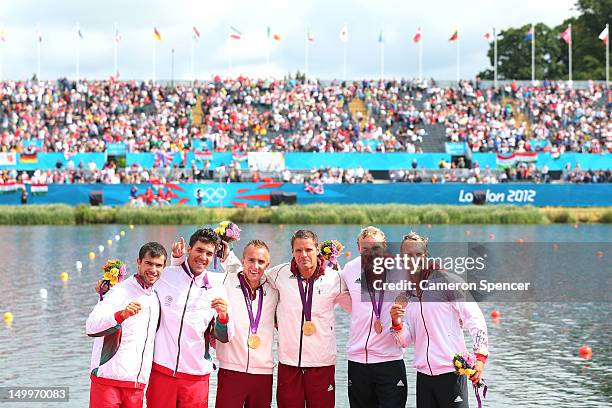 Roland Kokeny and Rudolf Dombi of Hungary stand on the podium after winning Gold, Emanuel Silva and Fernando Pimenta of Portugal the Silver and...