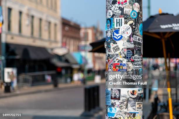 stickers on a lamp post on beale street, memphis - street light post stock pictures, royalty-free photos & images