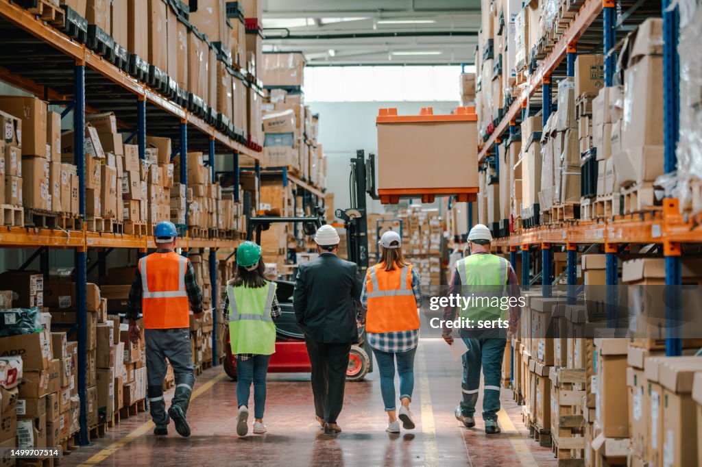 Collaborative Innovation: Brainstorming and Discussion in Factory Warehouse Corridor