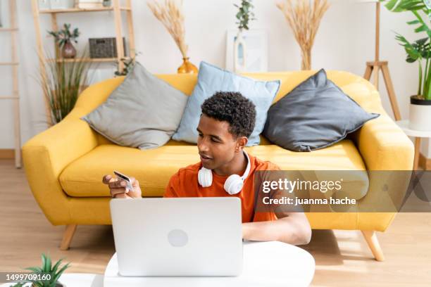 smiling black man working on laptop - morning sickness fotografías e imágenes de stock