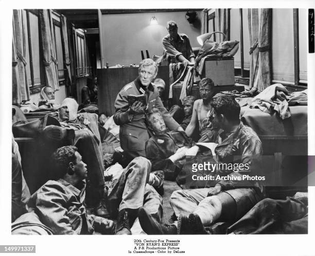 Edward Mulhare in room full of wounded men in a scene from the film 'Von Ryan's Express', 1965.