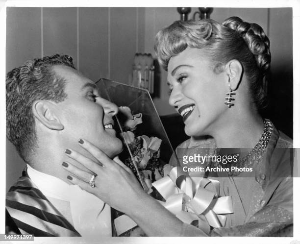 Robert Rockwell and Eve Arden share a happy moment in a scene from the film 'Our Miss Brooks', 1956.