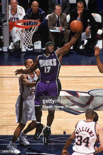 Forward Anthony Mason of the Milwaukee Bucks grabs a rebound during the NBA game against the New Jersey Nets at Continental Airlines Arena in East...