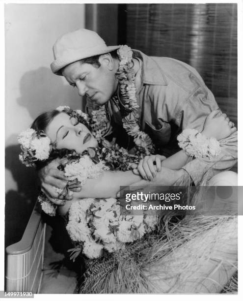 Martha Raye is held by Bob Burns in a scene from the film 'Waikiki Wedding', 1937.