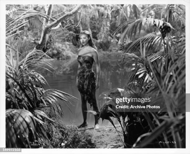 Adele Mara walking in the jungle in a scene from the film 'Wake Of The Red Witch', 1948.