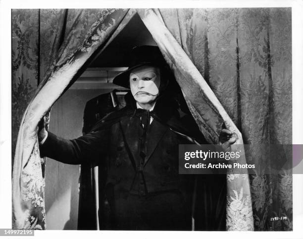 Claude Rains opening curtain in a scene from the film 'Phantom Of The Opera', 1943.