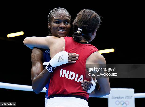 Mary Kom is embraced by Nicola Adams of Great Britain following their women's Flyweight boxing semi-final match of the 2012 London Olympic Games at...