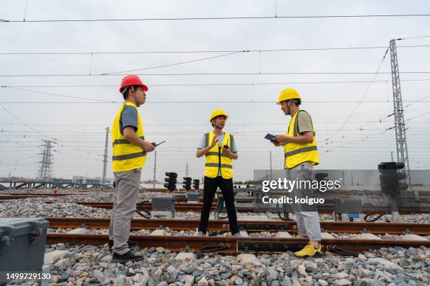 three railway workers patrolling the tracks - 共同工作者 stock pictures, royalty-free photos & images