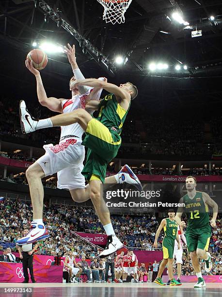 Timofey Mozgov of Russia goes up for a shot against Renaldas Seibutis of Lithuania in the first half during the Men's Basketball quaterfinal game on...