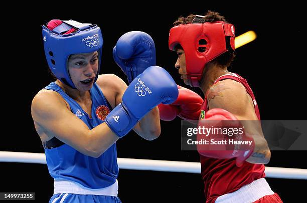 Sofya Ochigava of Russia in action against Adriana Araujo of Brazil during the Women's Light Boxing semifinals on Day 12 of the London 2012 Olympic...