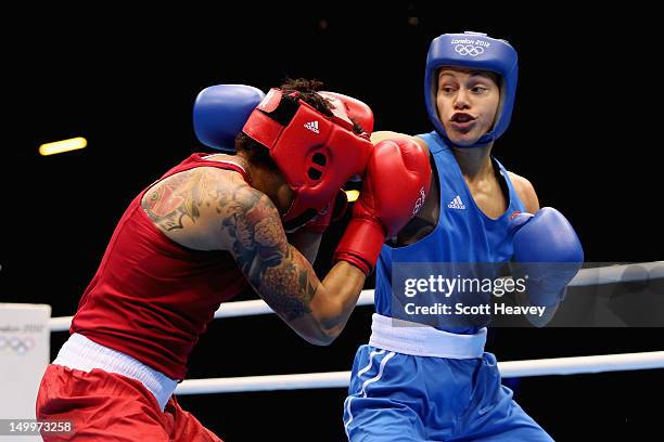 Adriana Araujo of Brazil in action against Sofya Ochigava of Russia during the Women's Light Boxing semifinals on Day 12 of the London 2012 Olympic...