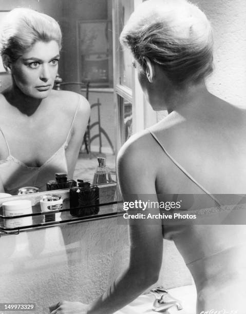 Melina Mercouri looking at herself in the mirror in a scene from the film 'Phaedra', 1962.