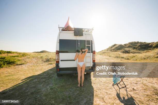 woman taking outdoor shower near the camper van - car back view bildbanksfoton och bilder