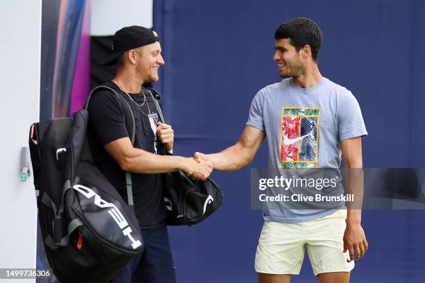 Alejandro Davidovich Fokina of Spain shakes hands with Carlos Alcaraz of Spain before their training session on Day One of the cinch Championships at...