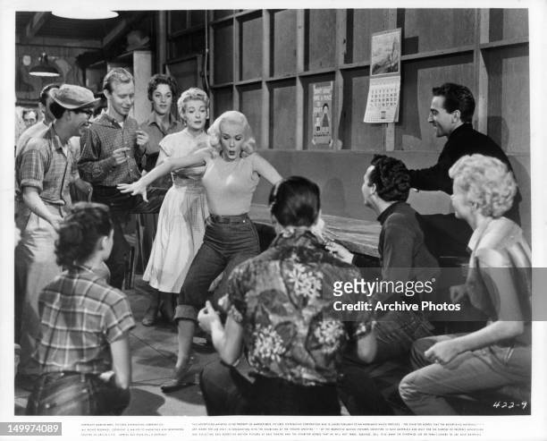 Mamie Van Doren performs in front of group of people in a scene from the film 'Untamed Youth', 1957.