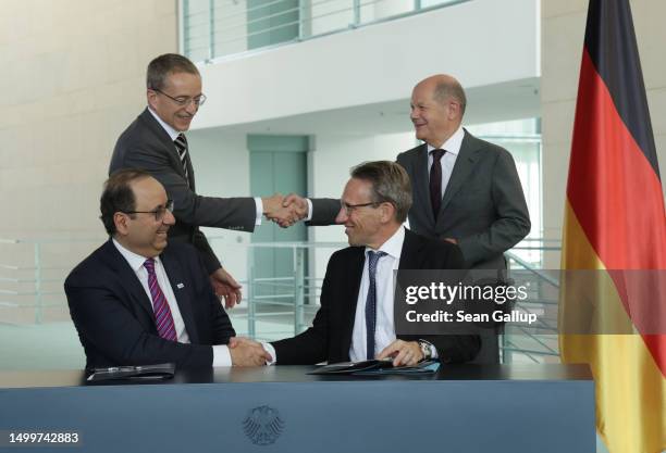 German Chancellor Olaf Scholz and Intel CEO Pat Gelsinger shake hands as State Secretary Joerg Kukies and Intel board member Keyvan Esfarjani also...