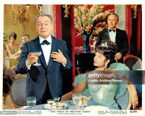 Edward G Robinson making toast as Daliah Lavi watches in a scene from the film 'Two Weeks In Another Town', 1962.