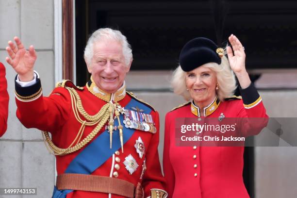 King Charles III and Queen Camilla wave as they watch the fly-past on the Buckingham Palace balcony during Trooping the Colour on June 17, 2023 in...