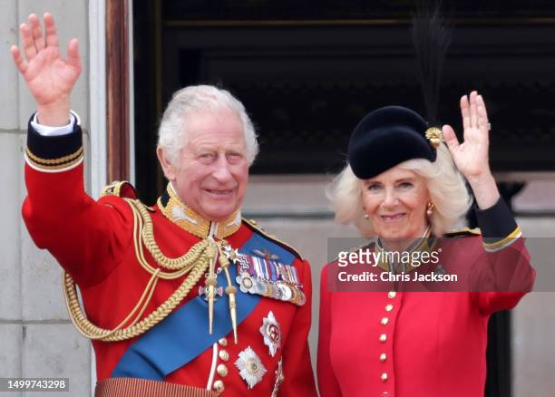 King Charles III and Queen Camilla wave as they watch the fly-past on the Buckingham Palace balcony during Trooping the Colour on June 17, 2023 in...