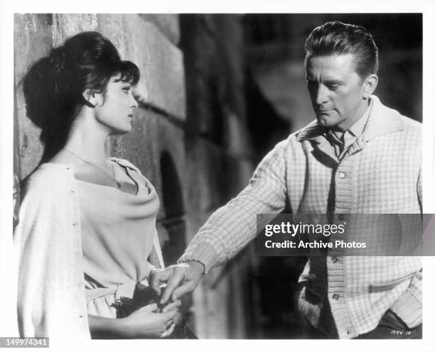Daliah Lavi watches as Kirk Douglas touches her hand in a scene from the film 'Two Weeks In Another Town', 1962.