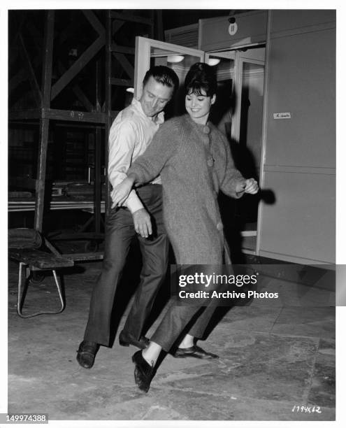 Kirk Douglas and Daliah Lavi learn dance moves in between takes from the film 'Two Weeks In Another Town', 1962.