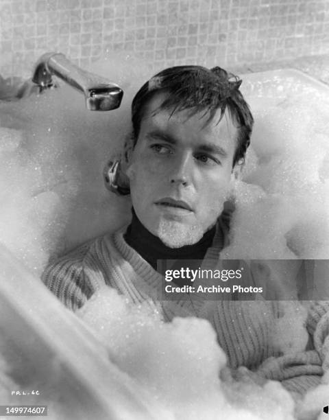 Robert Wagner in bubble bath with his clothes on in a scene from the film 'The Pink Panther', 1963.
