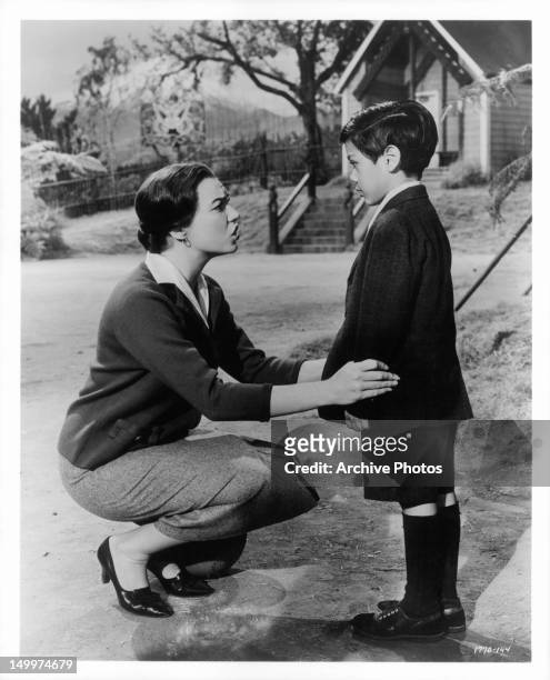 Shirley MacLaine attempts to convince young Edmund Vargas that ghosts do not exist in a scene from the film 'Two Loves', 1961.