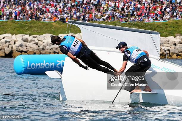 Peter Burling and Blair Tuke of New Zealand celebrate winning silver in the Men's 49er Sailing on Day 12 of the London 2012 Olympic Games at the...