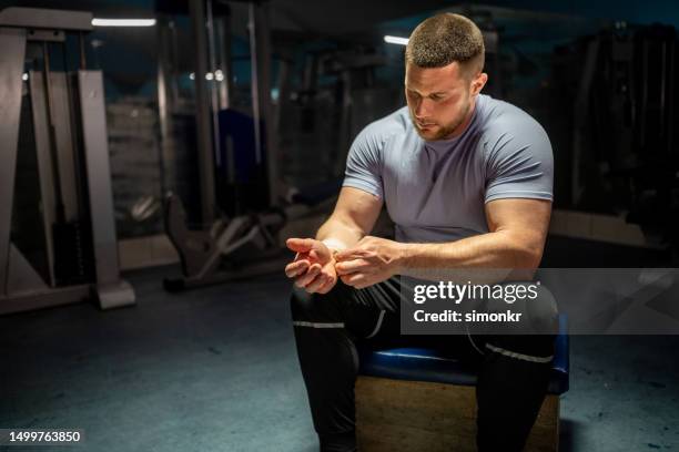 athlete wrapping bandage - joint effort stock pictures, royalty-free photos & images