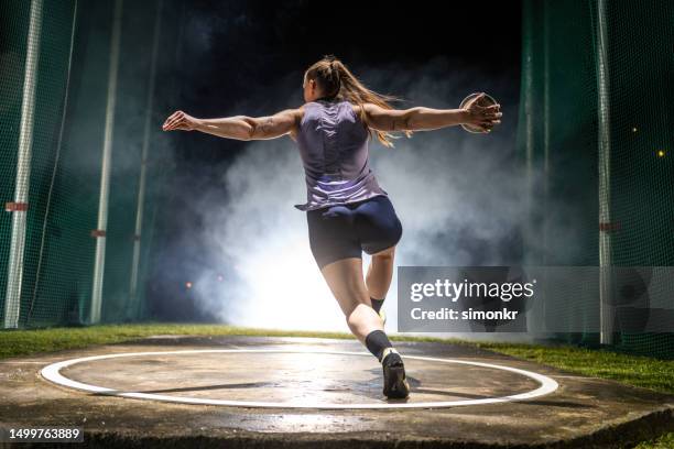 athlete woman throwing discus - extra long stock pictures, royalty-free photos & images