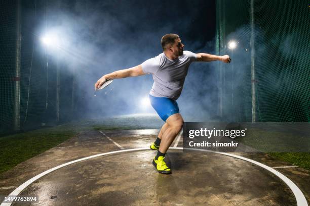 athlete man throwing discus - discus stock pictures, royalty-free photos & images
