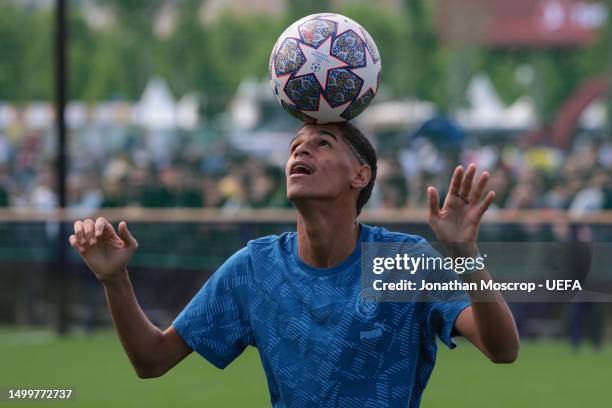 Social Media personality Luva de Pedreiro balances the ball on his head during the Ultimate Champions Match prior to the UEFA Champions League...