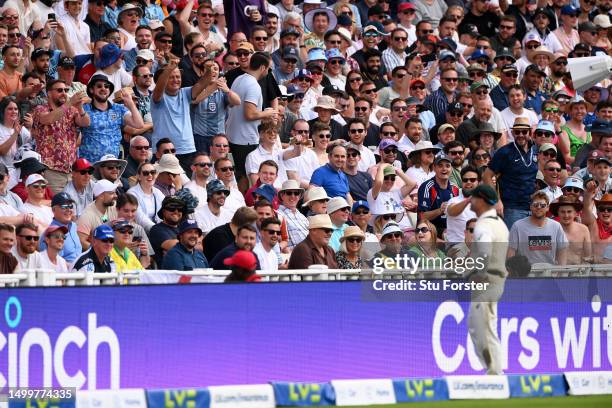 The crowd in the Hollies Stand interact with David Warner of Australia during Day Four of the LV= Insurance Ashes 1st Test match between England and...