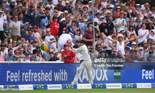 Travis Head of Australia throws a beach ball back into the Holllies Stand during Day Four of the LV= Insurance Ashes 1st Test match between England...