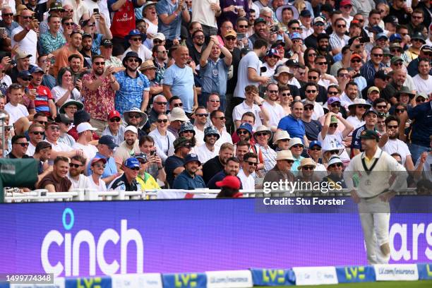 The crowd in the Hollies Stand interact with David Warner of Australia during Day Four of the LV= Insurance Ashes 1st Test match between England and...